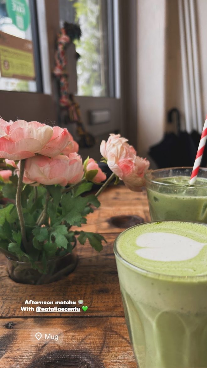 Matcha latte by the window with pink roses
