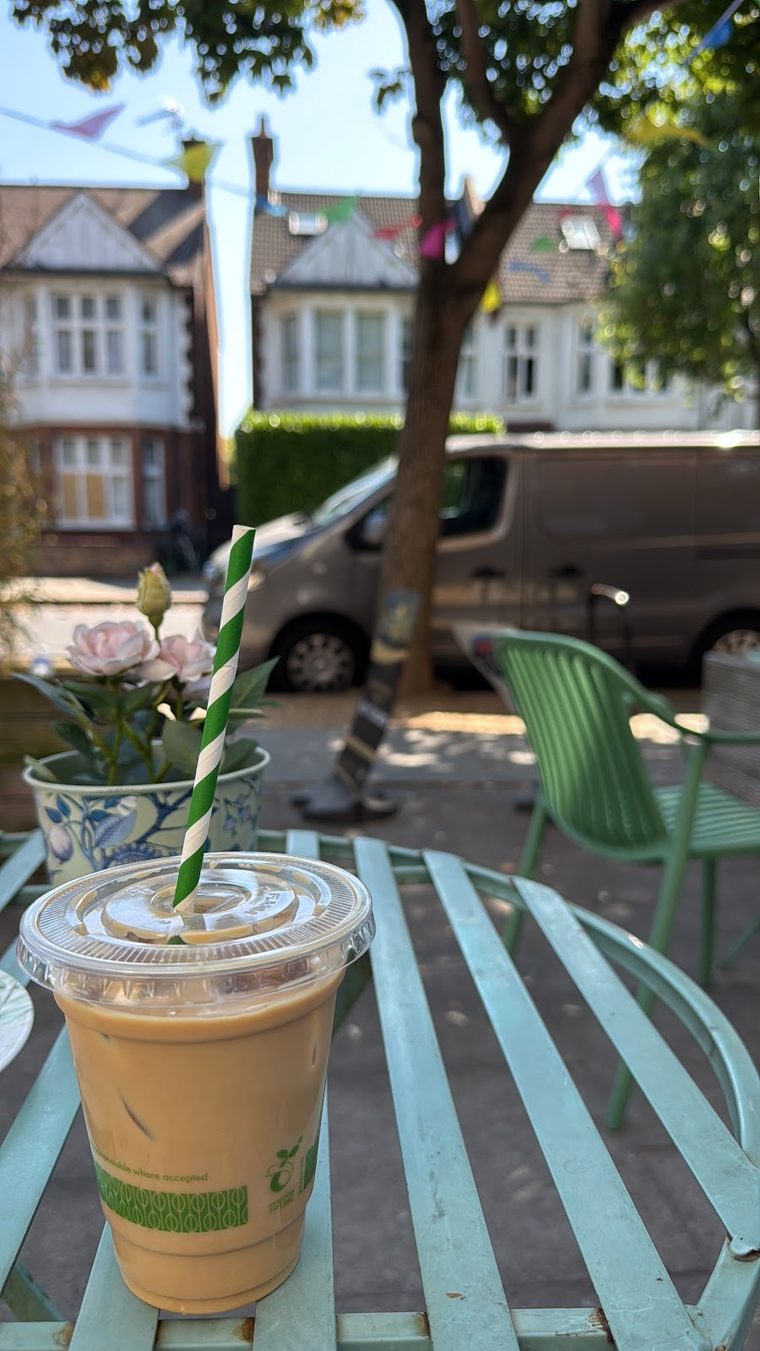Iced coffee in a takeaway cup on a pavement table